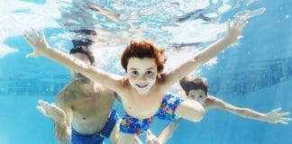 Family swimming in pool