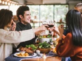 Dinner with friends. Group of young people enjoying dinner together. Dining Wine Cheers Party thanksgiving Concept