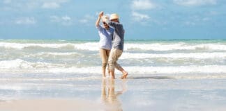 Senior Couple Dancing on Beach iStock 1322107306