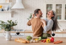 Happy Couple in Kitchen iStock 1328351784