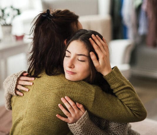 Bring Hope Now: Local Nonprofit Aims to Solve Youth Mental Health Crisis Teenager Hugging Parent iStock 1476266423