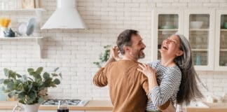 It’s Time to Exercise Happy Couple in Kitchen iStock 1328351784